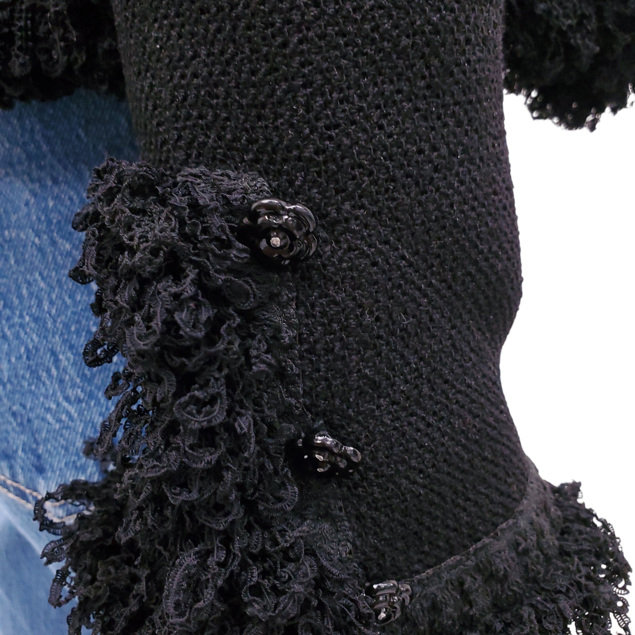 CHANEL BLACK TWEED SWEATER JACKET WITH FRINGE TRIM AND CAMÉLIA BUTTONS - SIZE 40