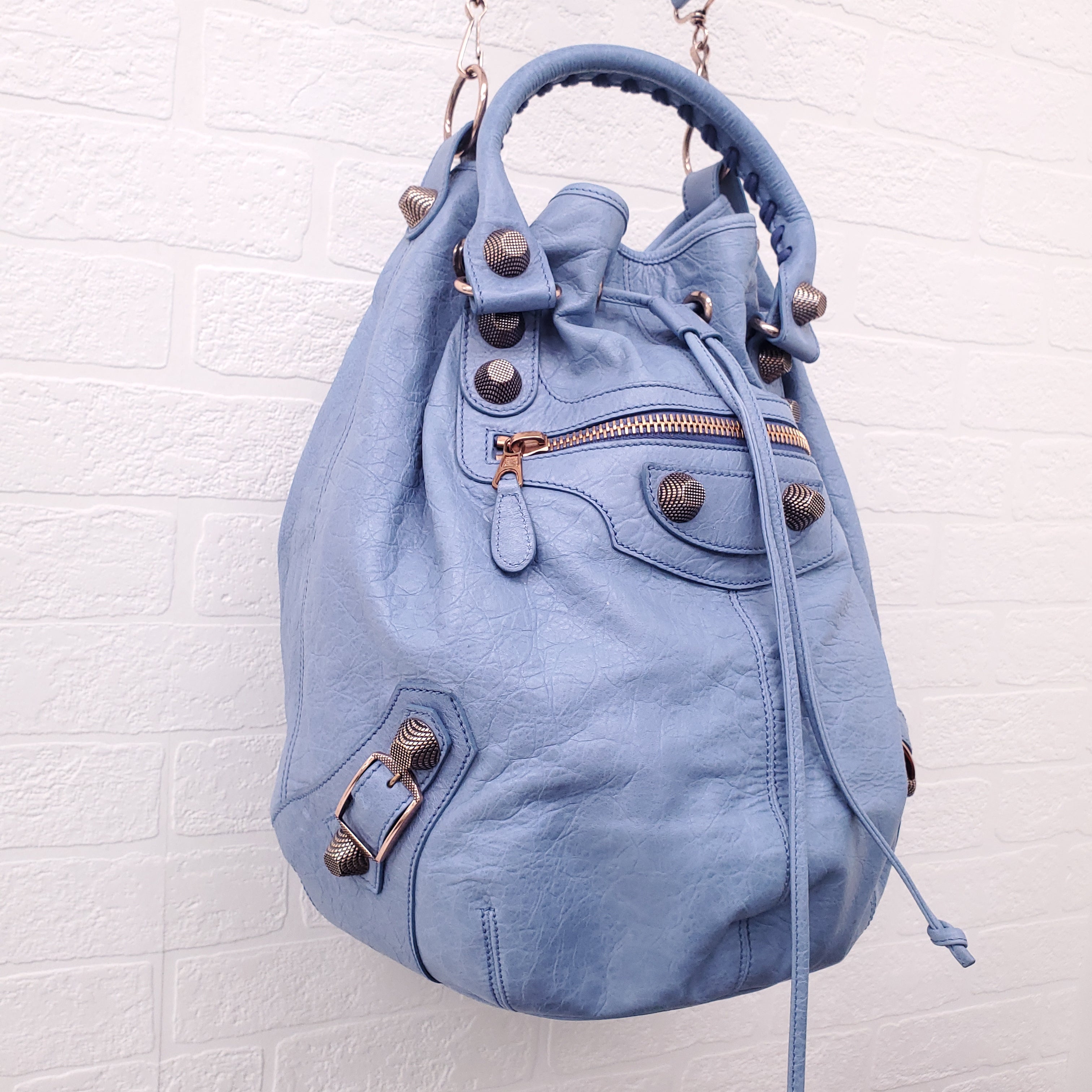 BALENCIAGA BLUE GIANT 'MOTOCROSS CITY' BUCKET BAG WITH ROSE GOLD GROMMETS