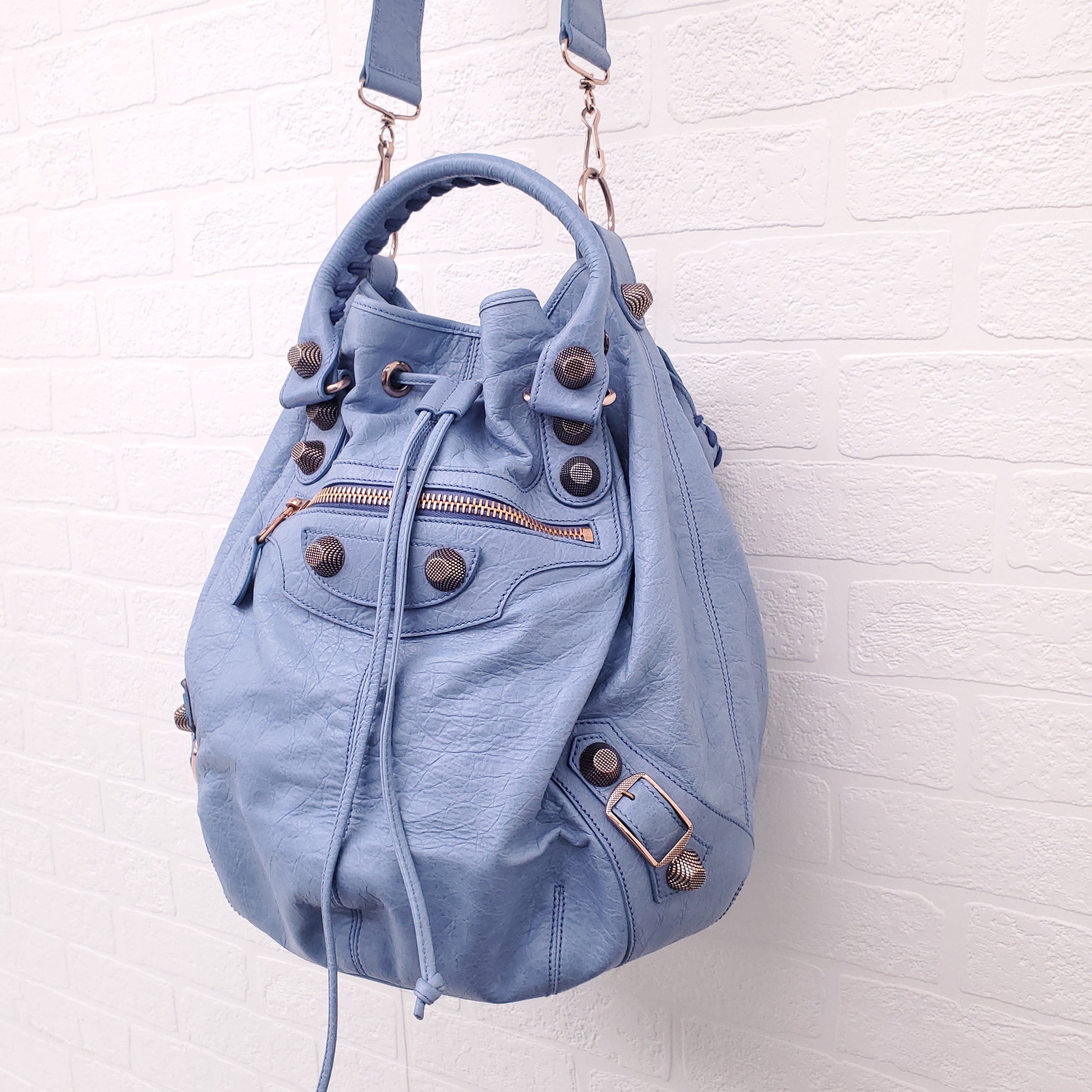 BALENCIAGA BLUE GIANT 'MOTOCROSS CITY' BUCKET BAG WITH ROSE GOLD GROMMETS