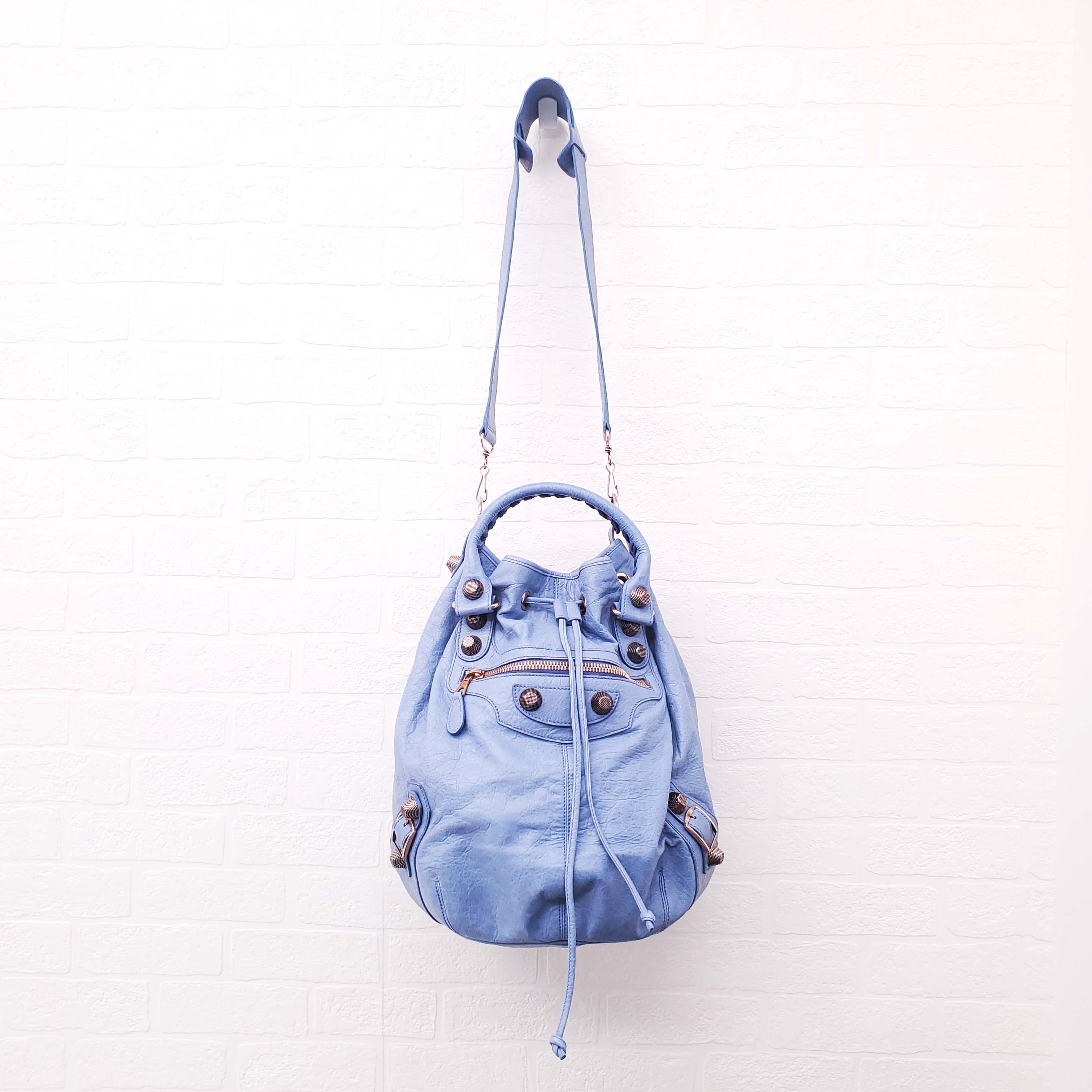 BALENCIAGA BLUE GIANT 'MOTOCROSS CITY' BUCKET BAG WITH ROSE GOLD GROMMETS