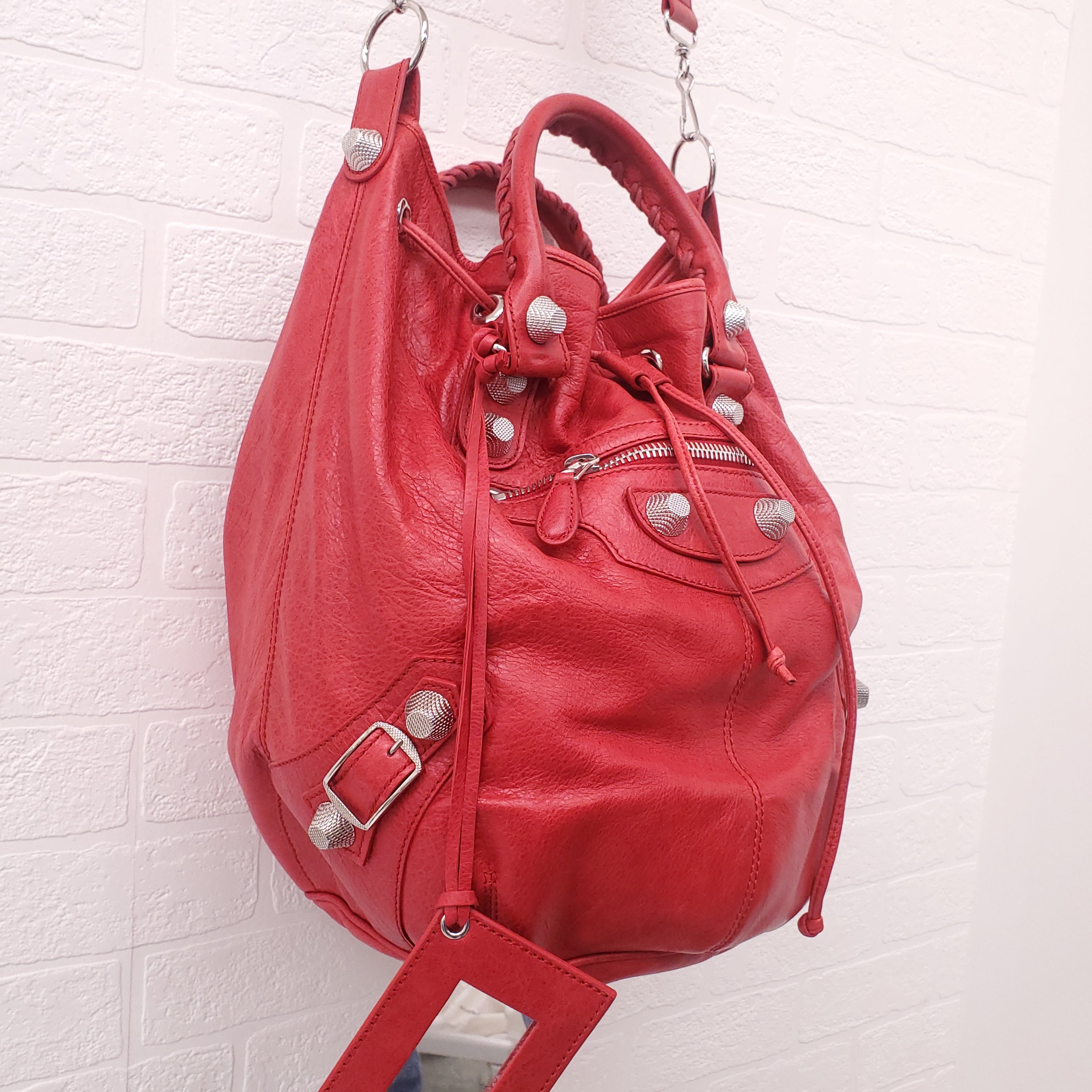 BALENCIAGA RED GIANT 'MOTOCROSS CITY' BUCKET BAG WITH SILVER GROMMETS