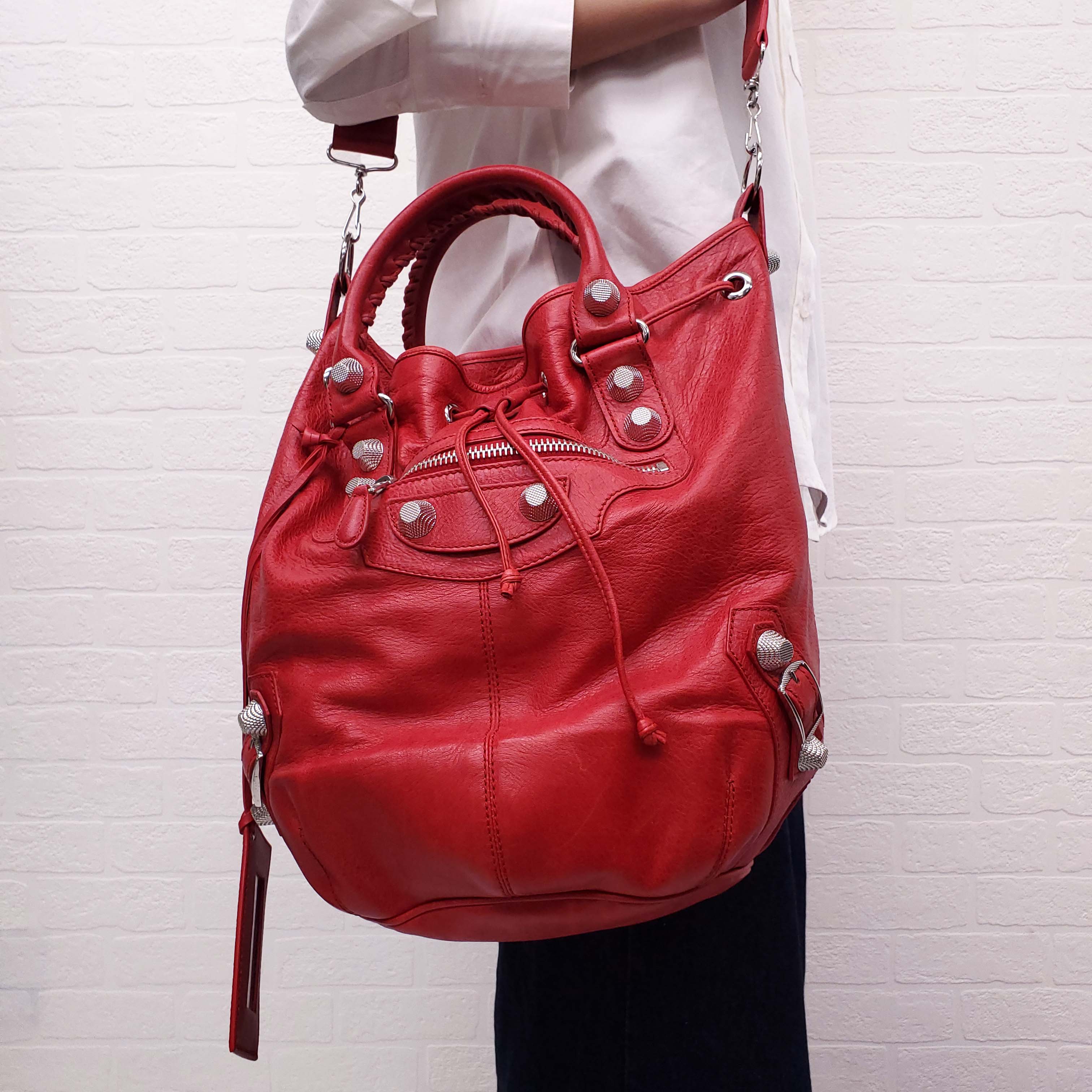 BALENCIAGA RED GIANT 'MOTOCROSS CITY' BUCKET BAG WITH SILVER GROMMETS