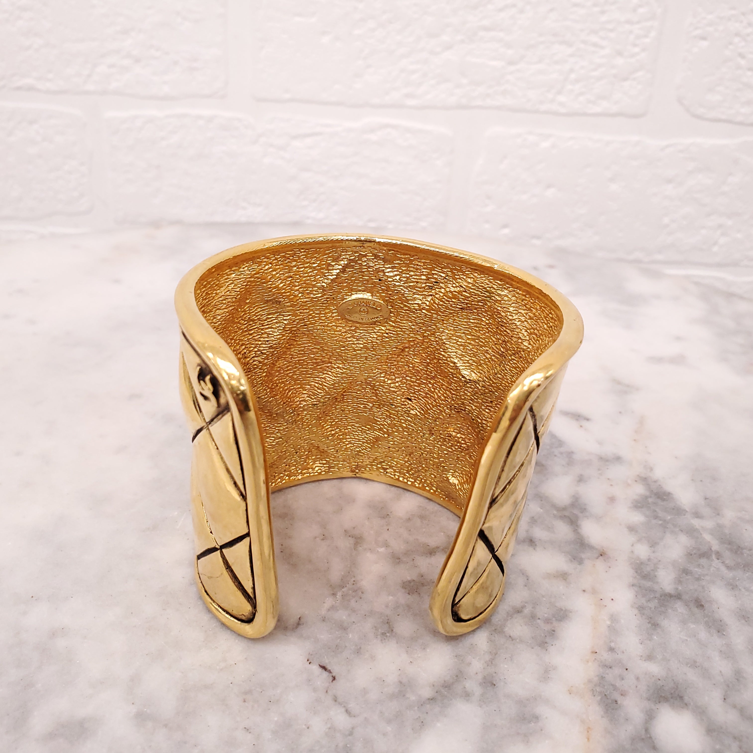 CHANEL CUFF WITH GOLD-TONED METAL AND QUILTED PATTERN