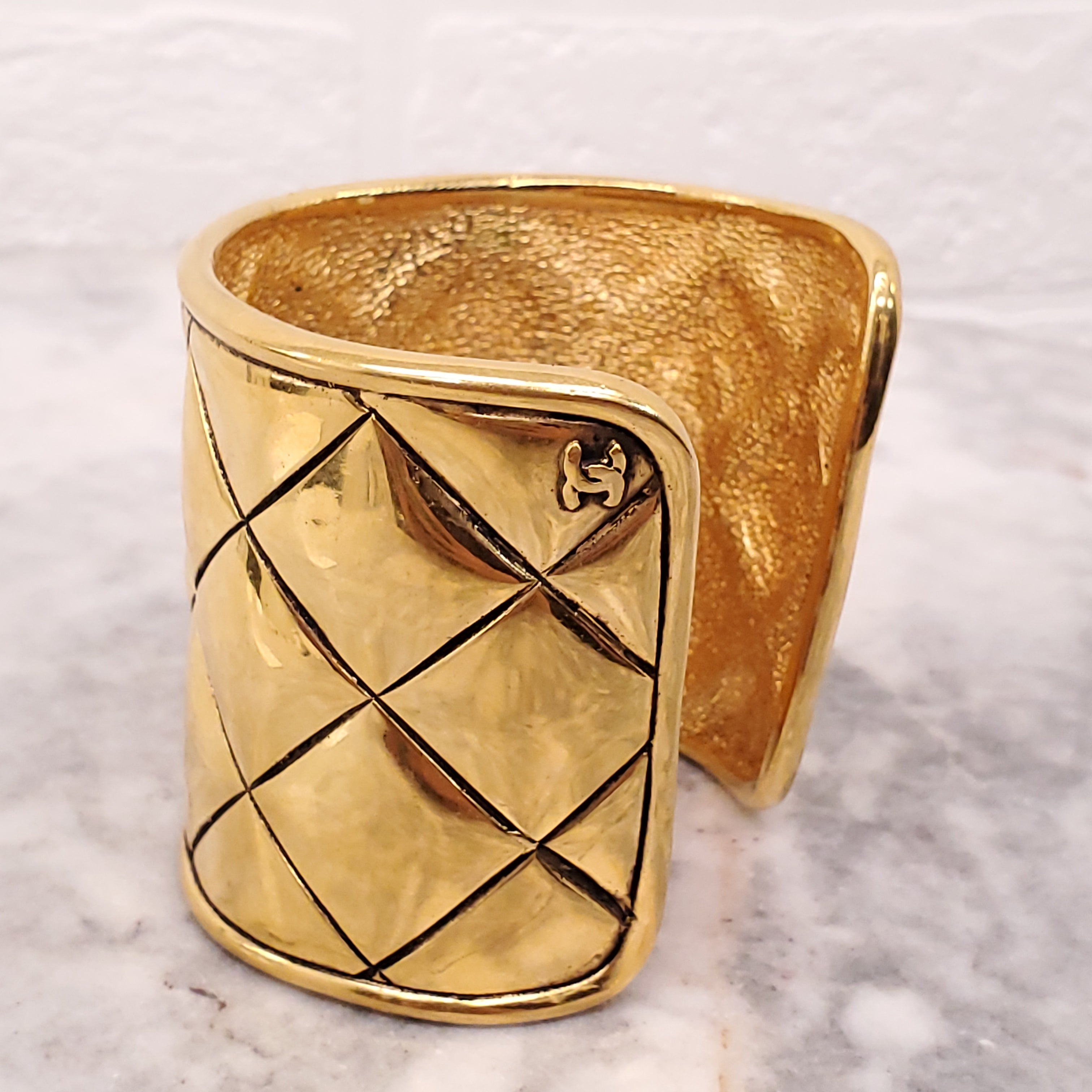 CHANEL CUFF WITH GOLD-TONED METAL AND QUILTED PATTERN