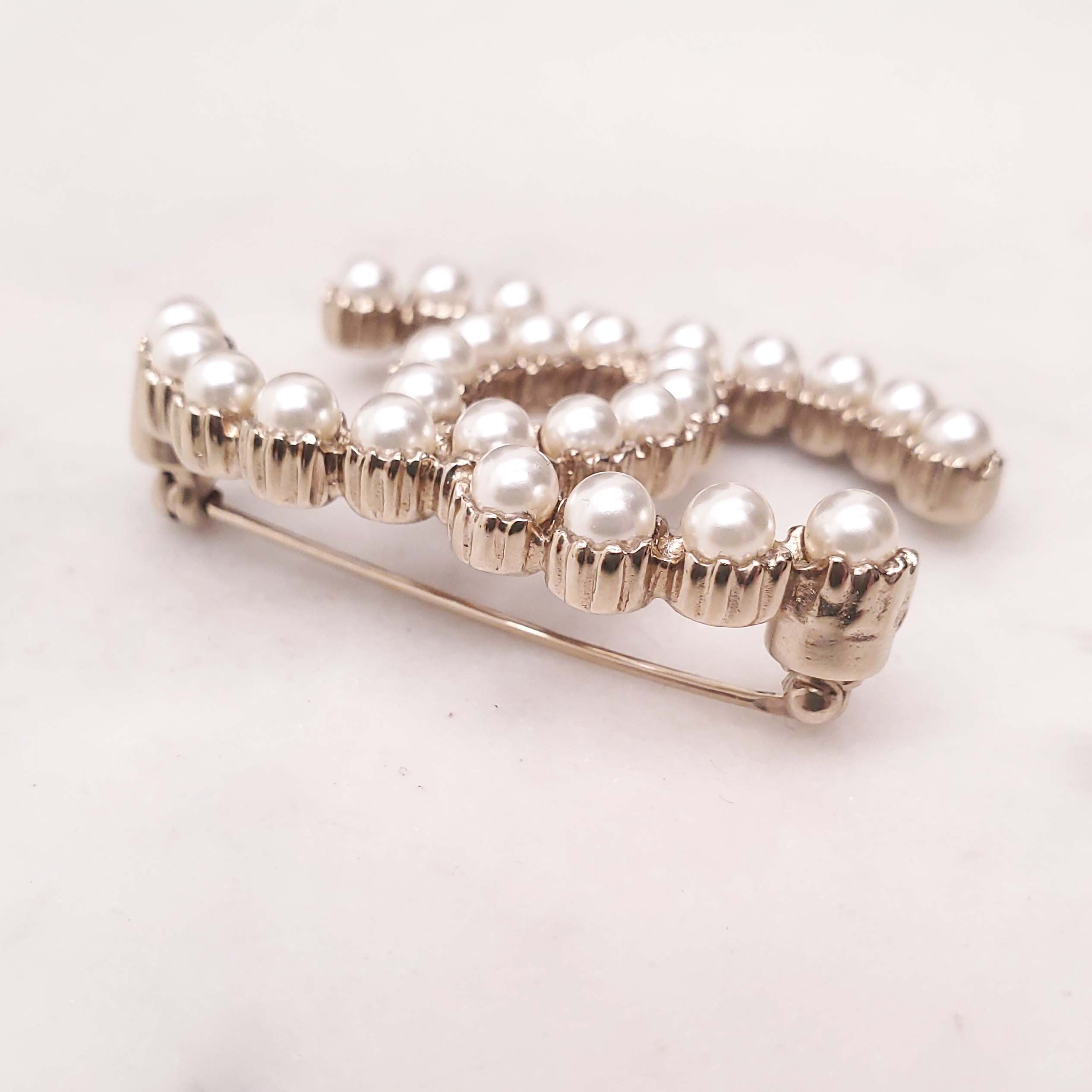 CHANEL PEARL LOGO BROOCH