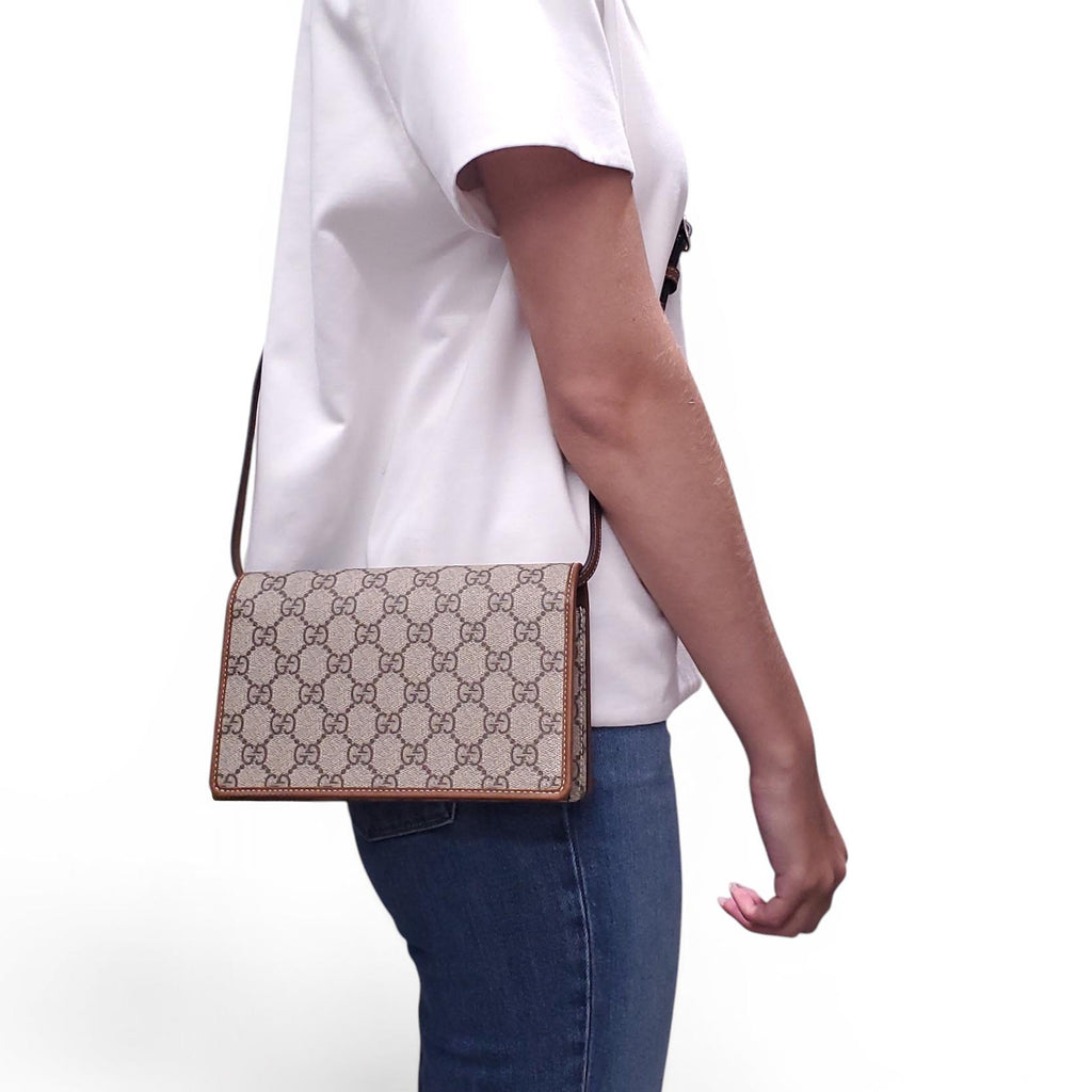 GUCCI GG EMBLEM WALLET WITH LEATHER STRAP