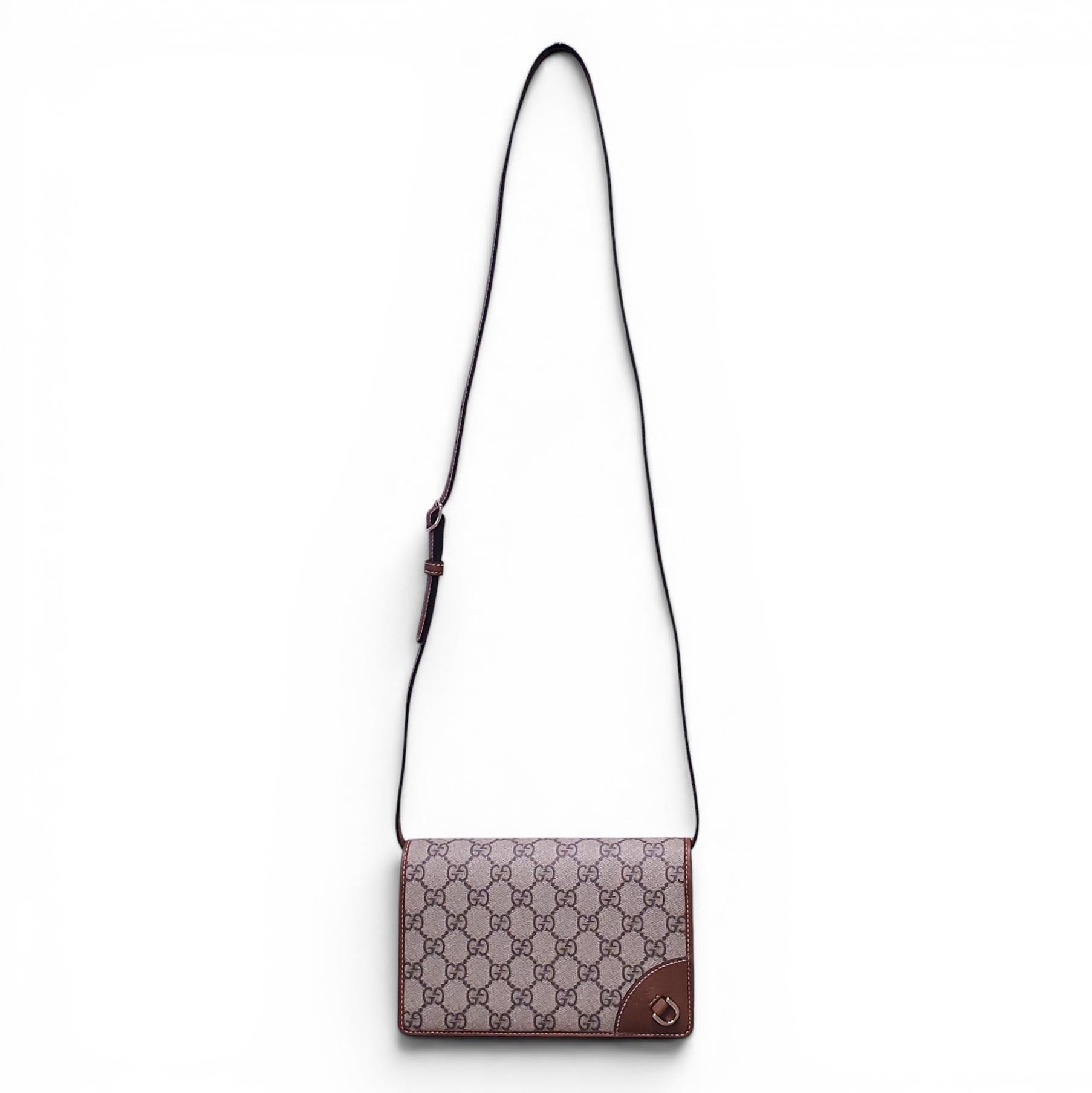 GUCCI GG EMBLEM WALLET WITH LEATHER STRAP