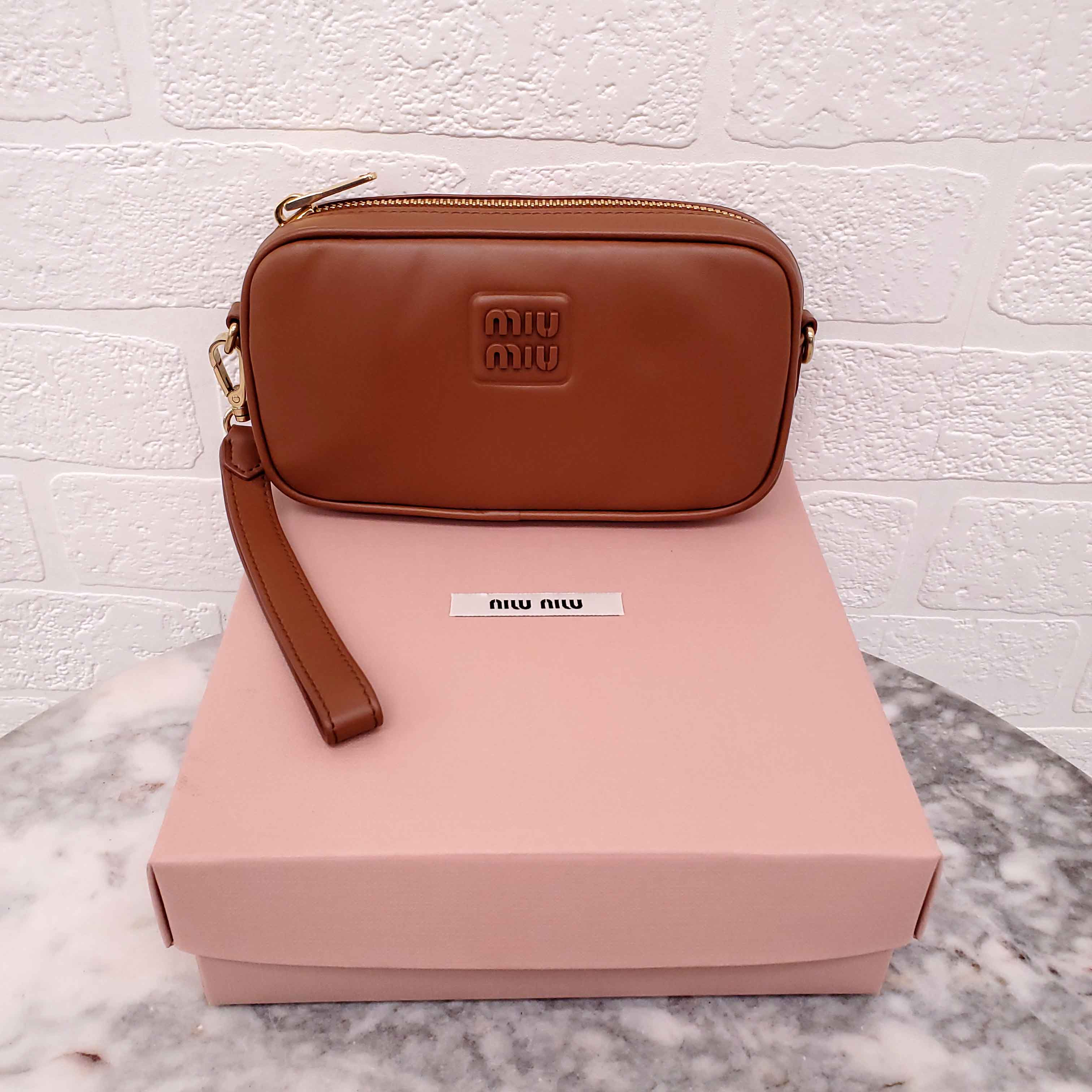 MIU MIU BROWN WRISTLET BAG WITH EMBOSSED LOGO