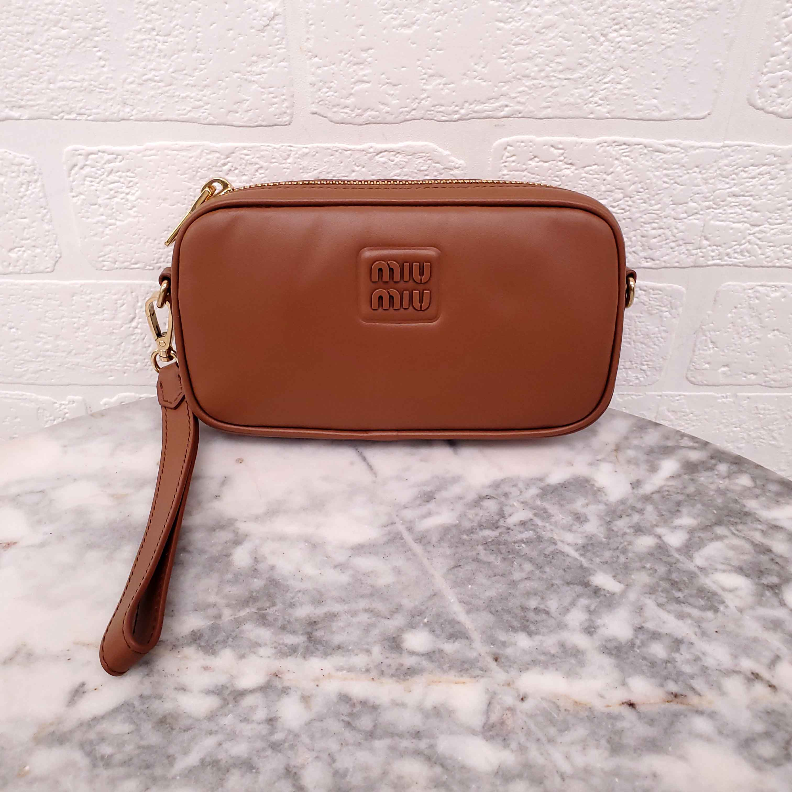 MIU MIU BROWN WRISTLET BAG WITH EMBOSSED LOGO
