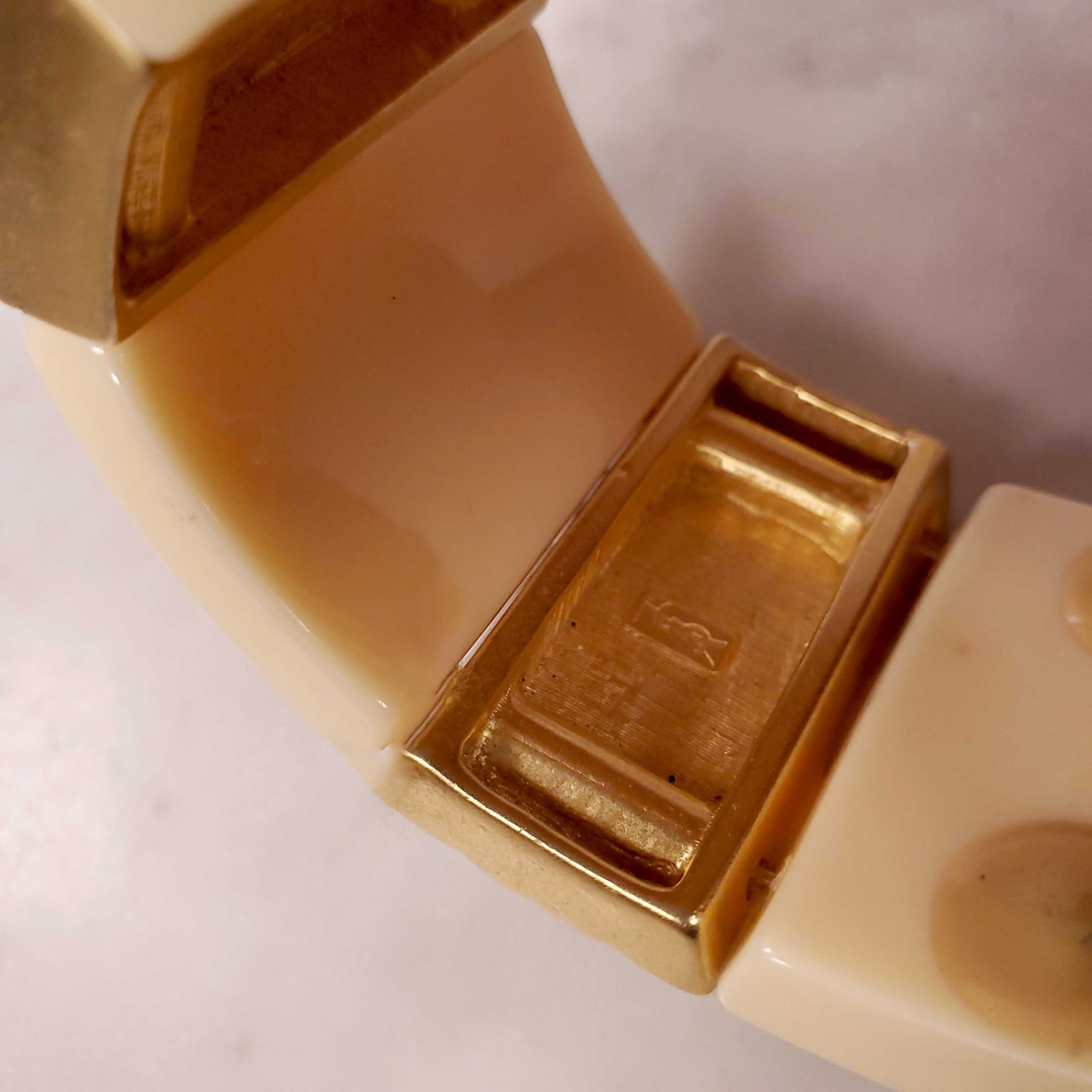 YVES SAINT LAURENT EXPANSION BRACELET WITH AMBER CABOCHONS SET IN CREAM AND GOLD-COLOURED PLASTIC